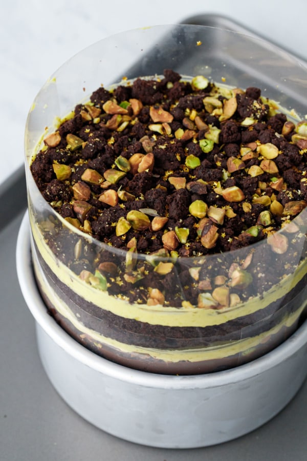 The finished Chocolate Pistachio Naked Layer Cake, still wrapped in acetate. Now refrigerate until set.