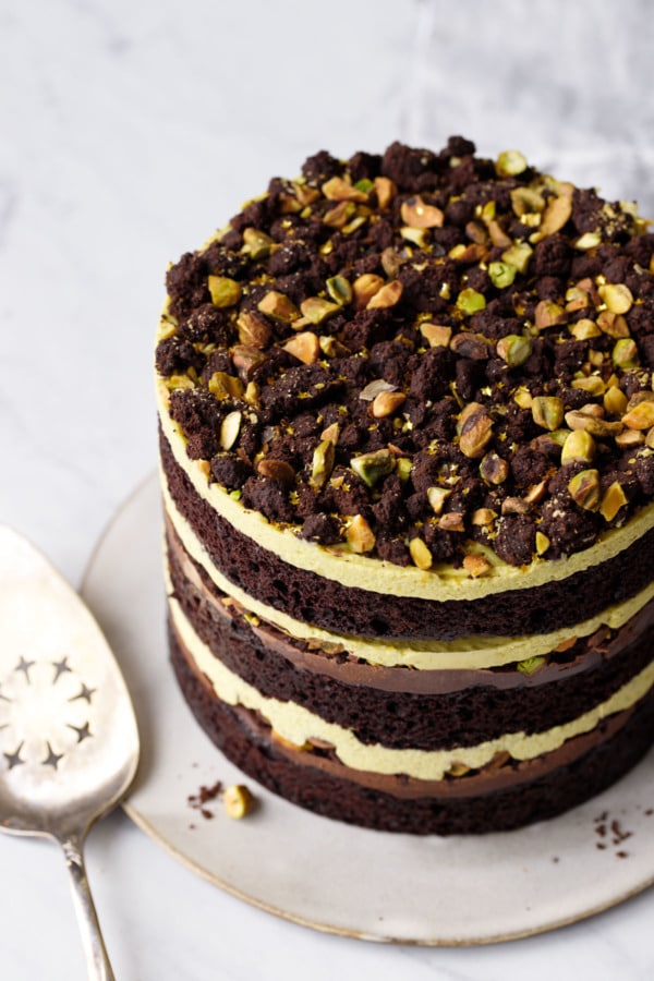 The gorgeous layers of this chocolate pistachio layer cake, with a crunchy crumb topping.