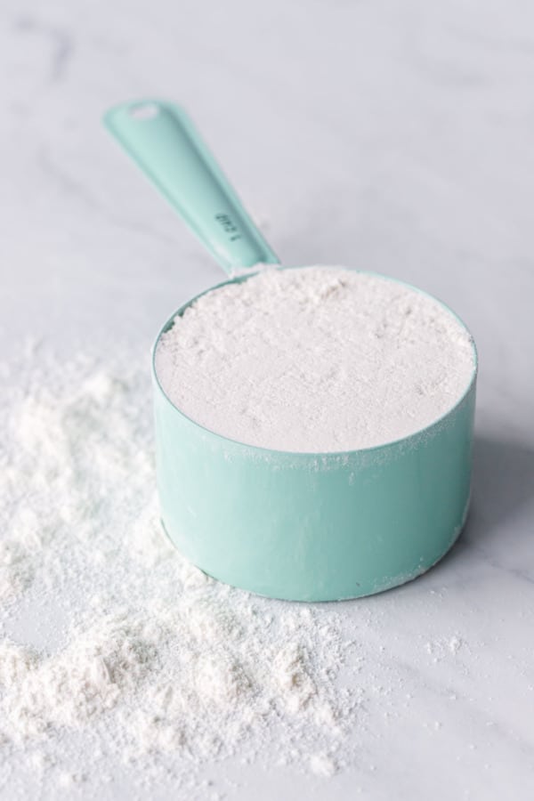 1 level cup of flour in a turquoise measuring cup