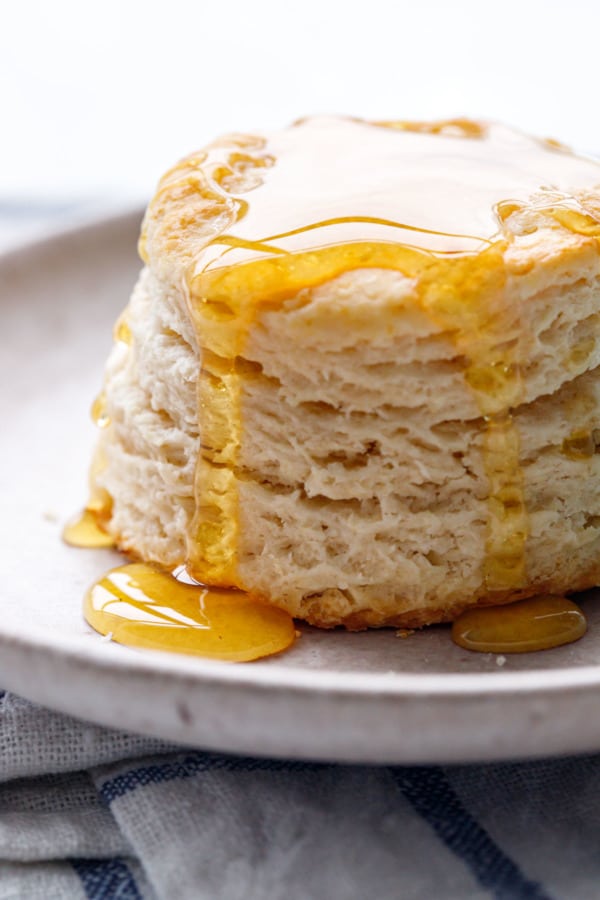 A sourdough biscuit drizzled with golden honey