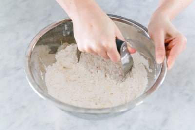 How to make Sourdough Biscuits: Cut the butter into the flour with a pastry cutter.