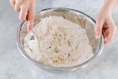 How to make Sourdough Biscuits: Mix with a fork, adding milk until the dough comes together.