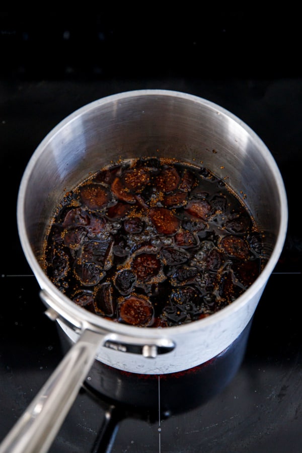 Simmering dried figs in syrup to make homemade fig syrup