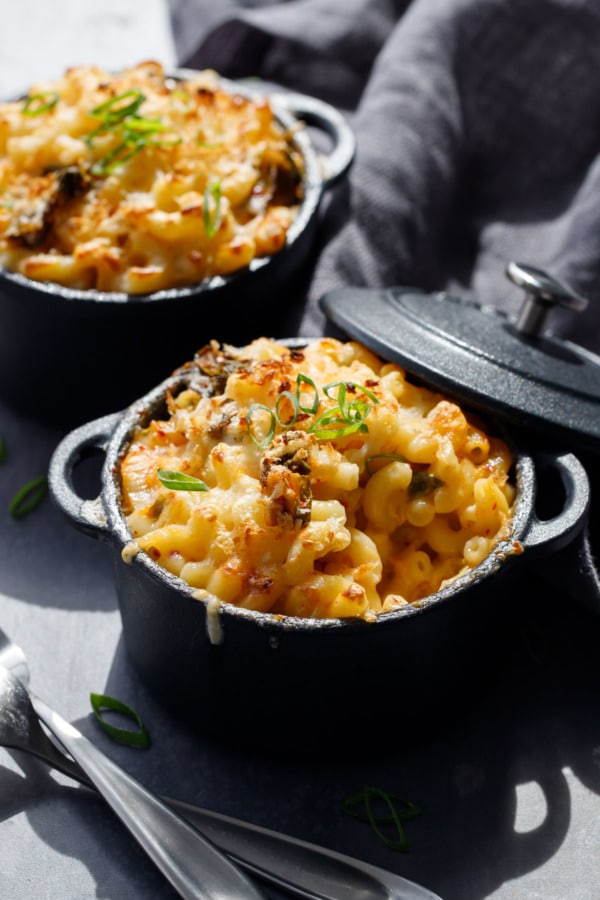 Kimchi Macaroni & Cheese in black ramekins with a scoop taken out