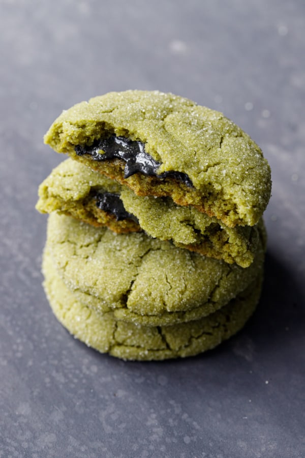 Stack of Black Sesame-Stuffed Matcha Sugar Cookies, the top cookie broken to show the filling.