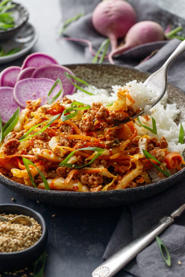 Forkful of Spicy Korean Egg Roll Bowls with purple radish