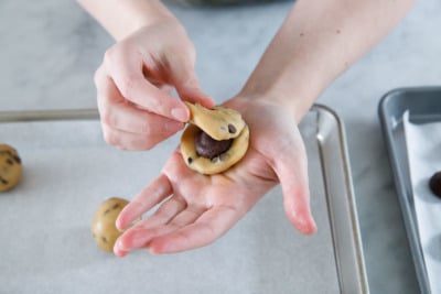 Sandwiching the ganache between two pieces of dough.