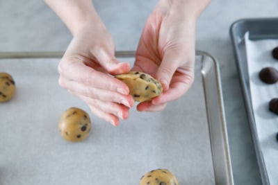 Sealing the edges around the ganache filling.