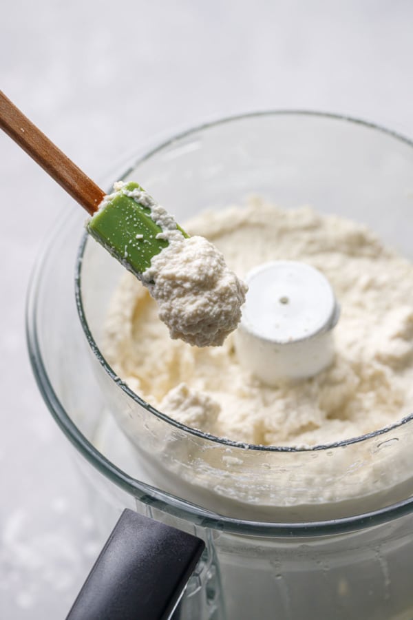 Whipped almond dip in a food processor, the texture similar to hummus and whipped ricotta