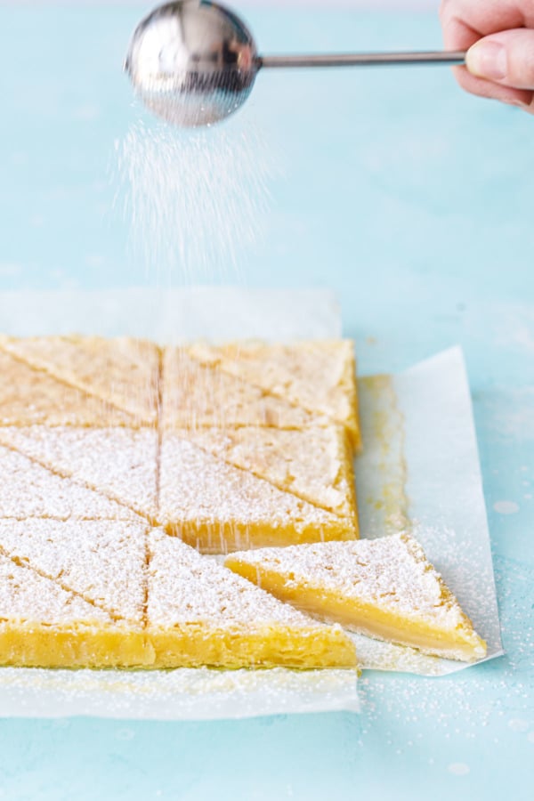 Dusting Meyer Lemon Bars with powdered sugar