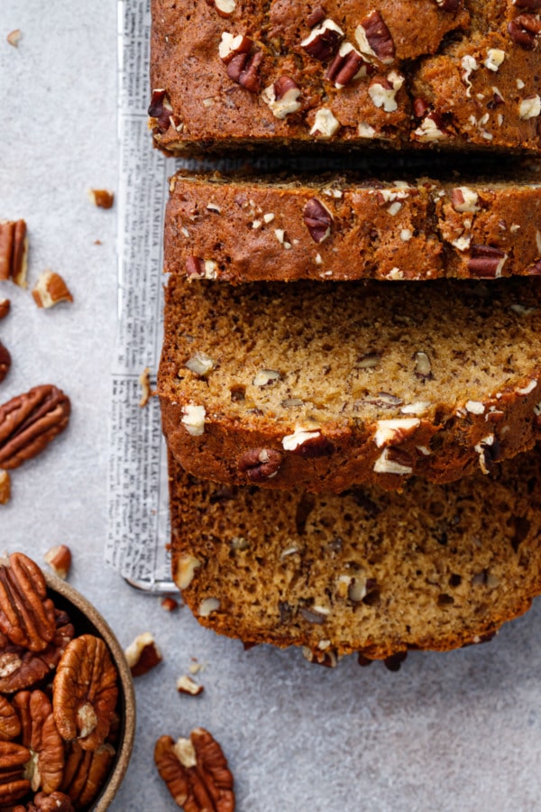 Sliced loaf of Bananas Foster Banana Bread with pecans