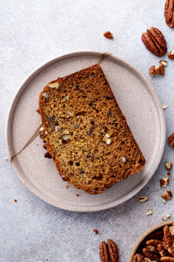 Overhead slice of Bananas Foster Banana Bread on a ceramic plate