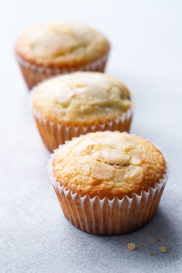 Row of three Sourdough Muffins on a gray background