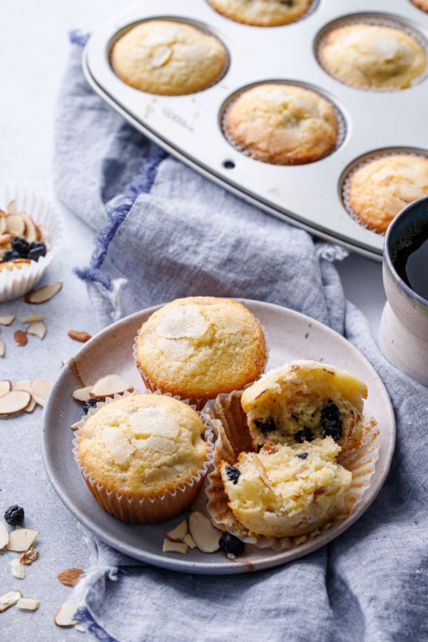 Plate of Sourdough Muffins with Dried Blueberries and Almonds, linen napkin and muffin tin