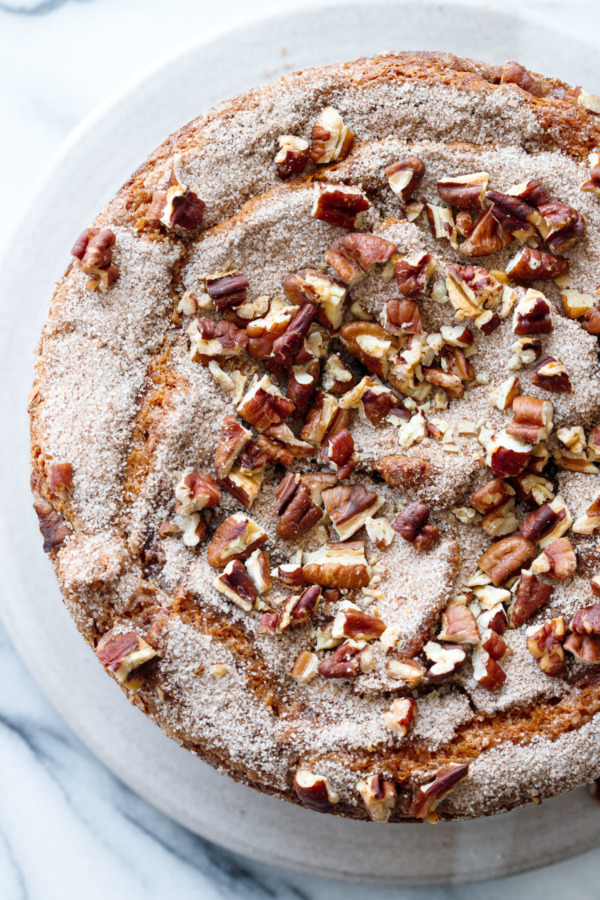 Overhead detail of round coffee cake with sugar and pecan topping