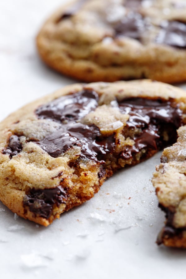 Closeup of half a cookie showing the texture and gooey chocolate puddles