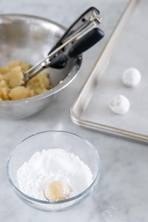 Shaping the cookies and rolling in powdered sugar