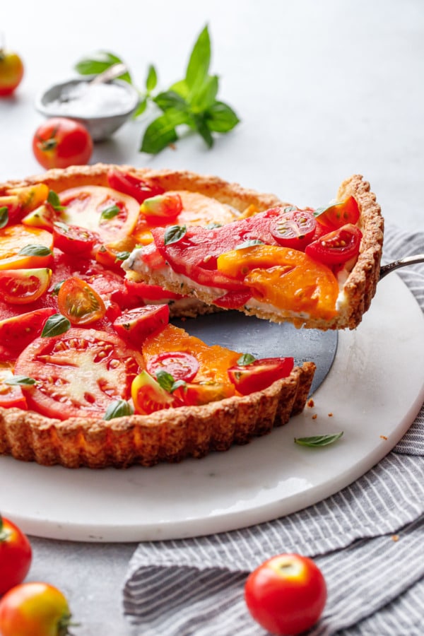 Lifting a slice of heirloom tomato tart