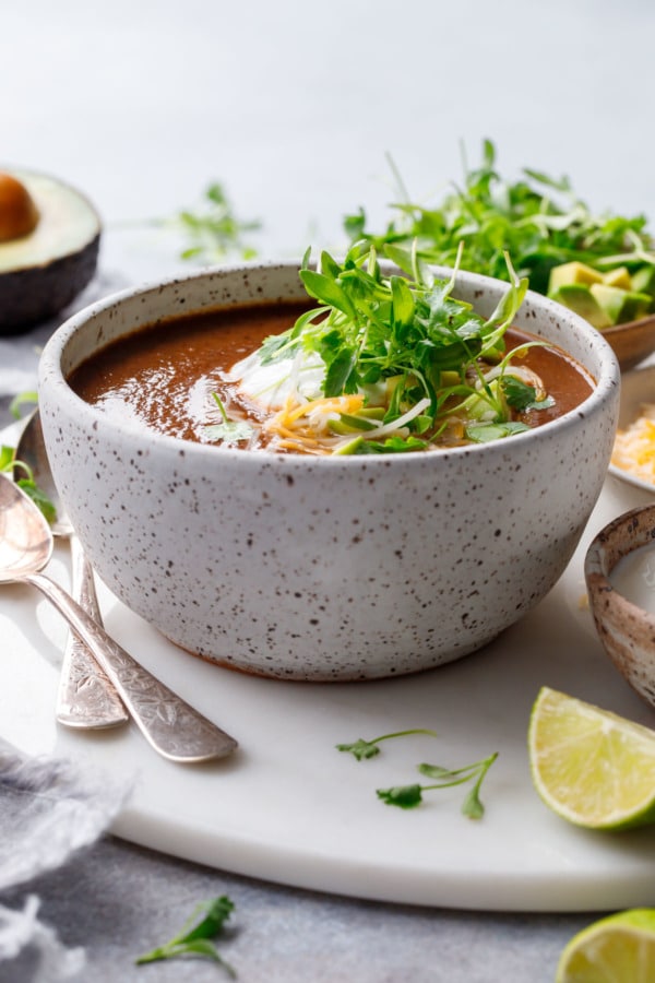 Black Bean Soup in a ceramic bowl topped with cilantro microgreens