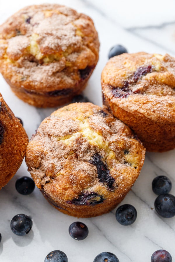 Golden brown blueberry coffee cake muffins on marble