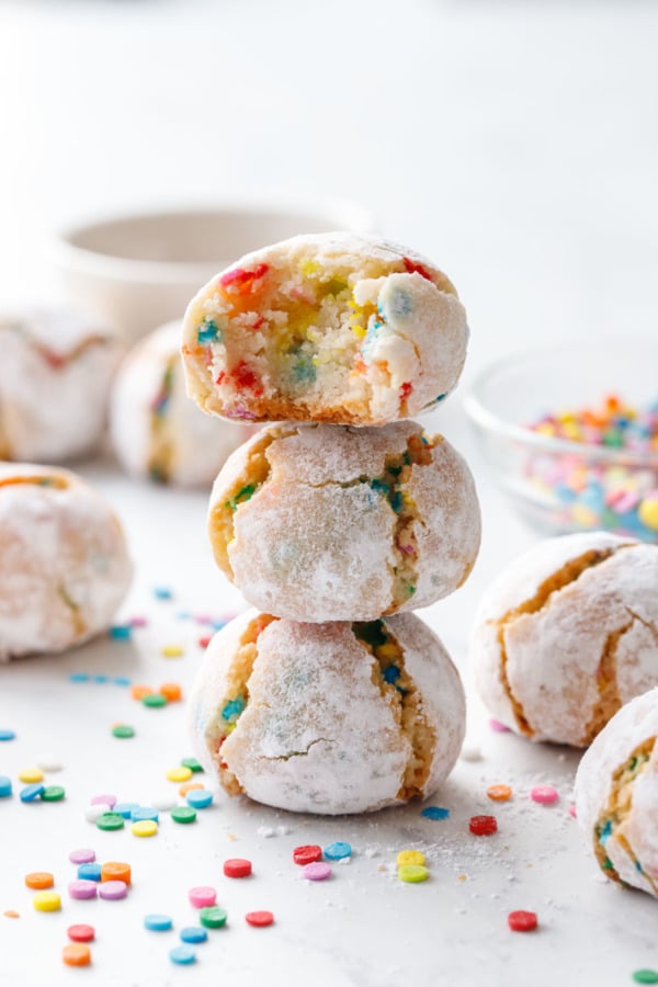 Stack of three funfetti amaretti cookies with rainbow sprinkles