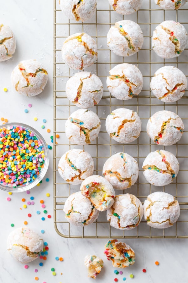 Overhead of amaretti cookies with sprinkles on a marble background