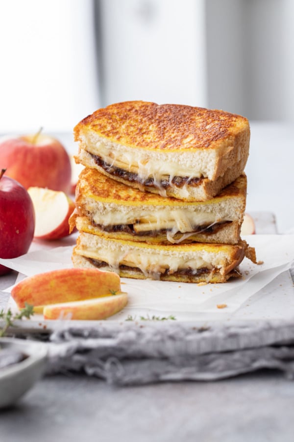 Stack of apple butter grilled cheese halves on a platter