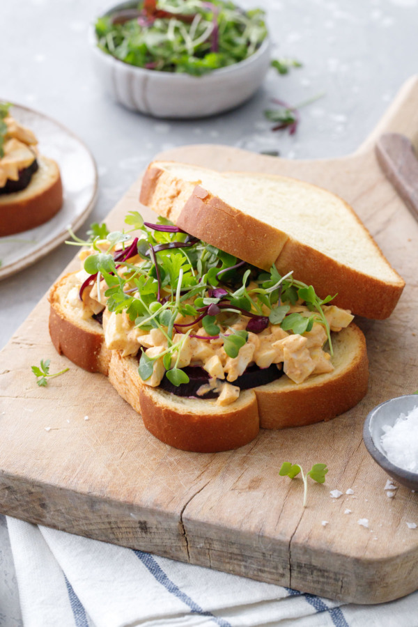 Egg salad sandwich with roasted beets and microgreens