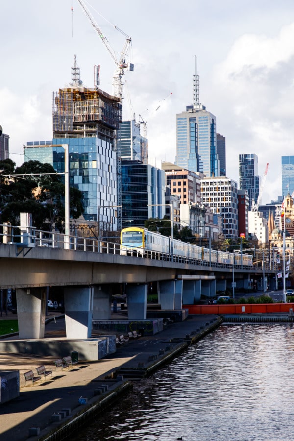 Riverfront, Melbourne, Australia, with yellow tram and buildings.