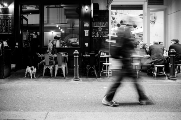 Cafe in Melbourne, Australia with motion-blurred people walking by