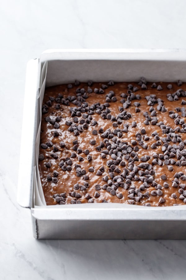 Cake pan with batter and chocolate chips, before baking