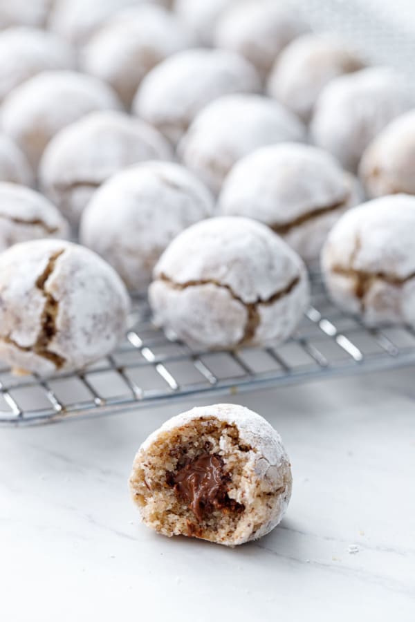 Closeup of a Hazelnut Amaretti Cookie with a bite, showing the Nutella filling inside