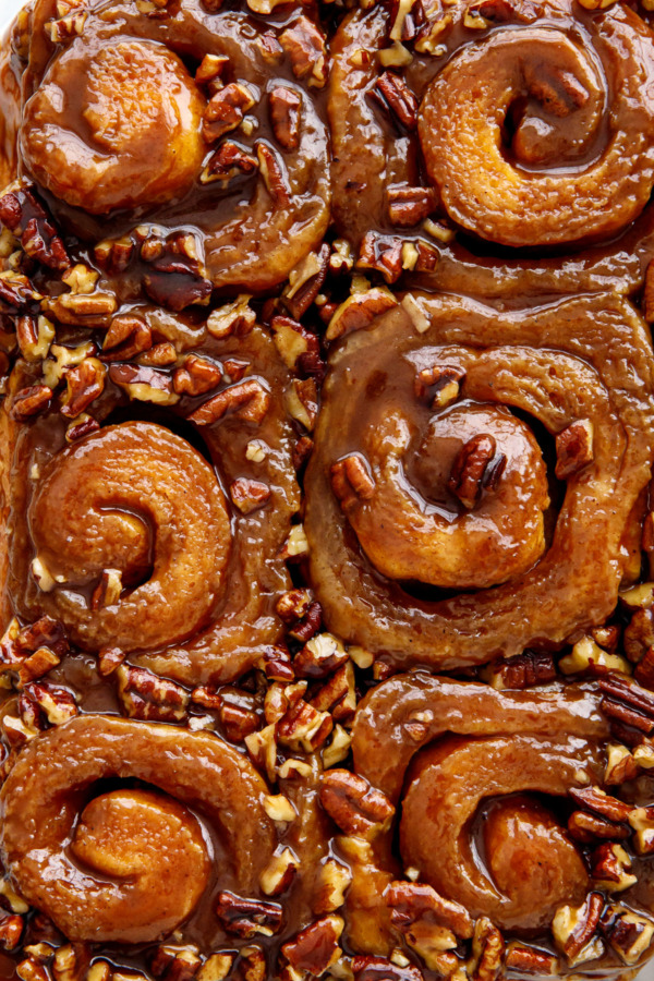 Closeup overhead of sticky buns showing spirals and pecans