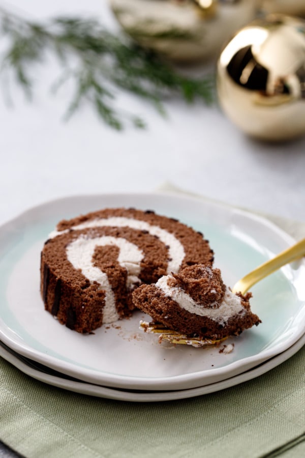 Slice and forkful of Chocolate Chestnut Christmas Cake Roll, showing the light and fluffy texture and chestnut cream filling