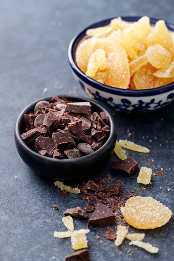 Small bowls of chopped dark chocolate and candied ginger