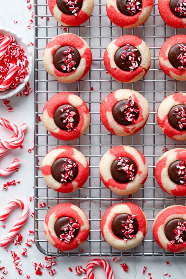 Overhead Chocolate Peppermint Thumbprints on a wire cooling rack with crushed candy canes