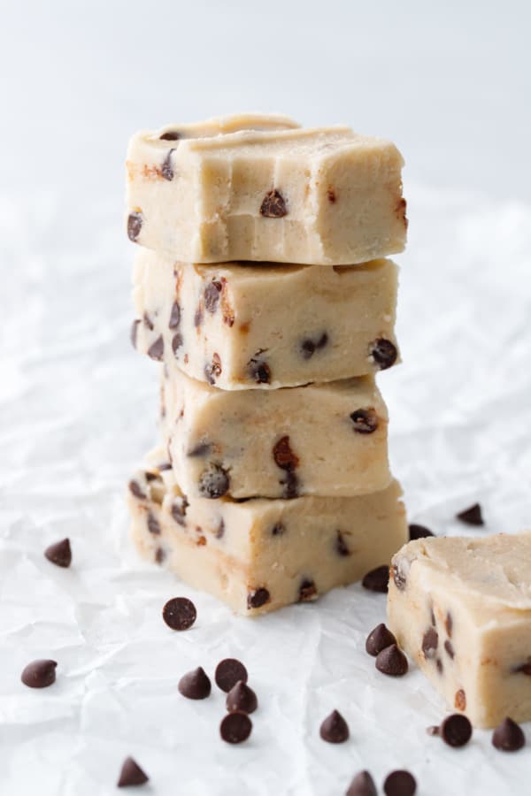 Stack of Chocolate Chip Cookie Dough Fudge, top piece with a bite out of it