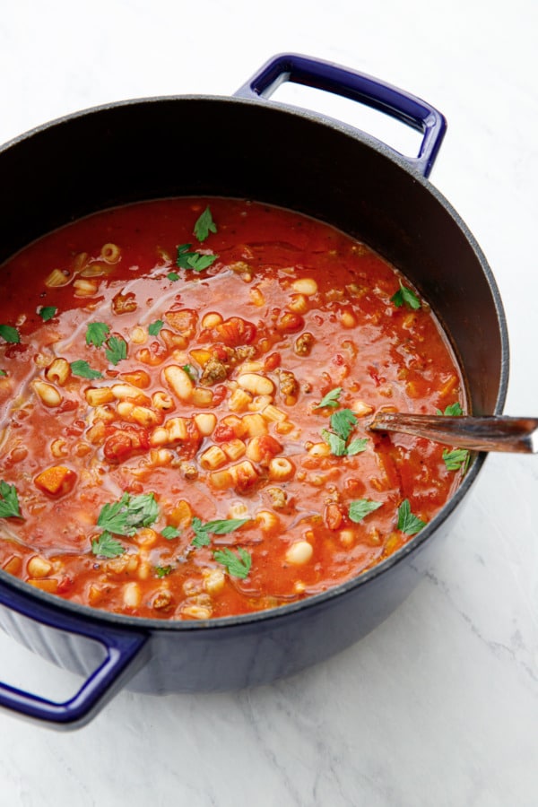 Blue Dutch Oven with Pasta e Fagioli soup and silver ladle