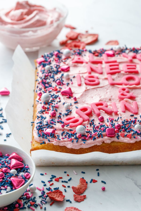 Yellow sheet cake with pink strawberry buttercream, with lots of pink and navy sprinkles