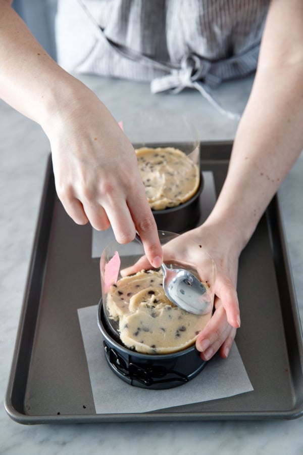 Assembling the milk-bar style naked cake: spread cookie dough onto cake layers