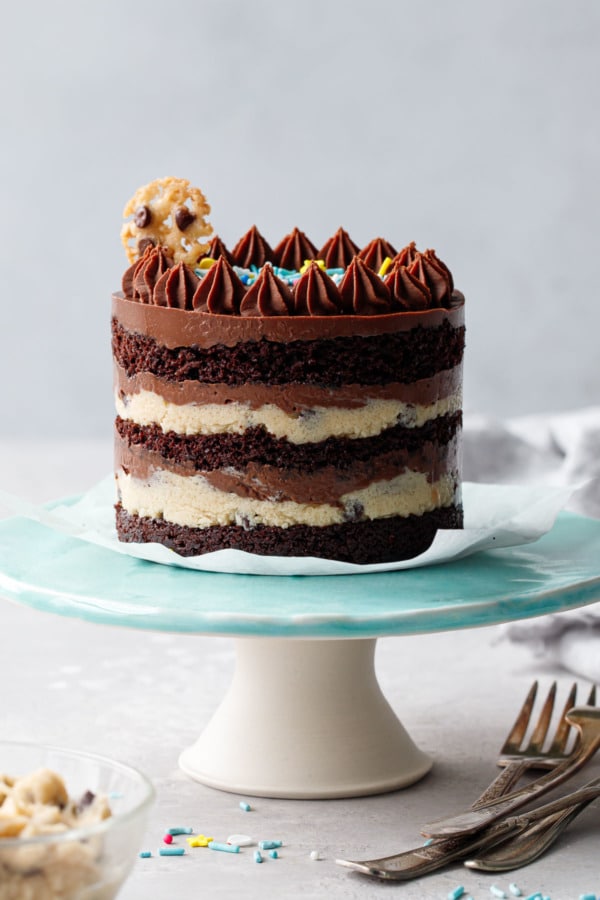 One Mini Chocolate & Cookie Dough Naked Layer Cake on a turquoise cake stand