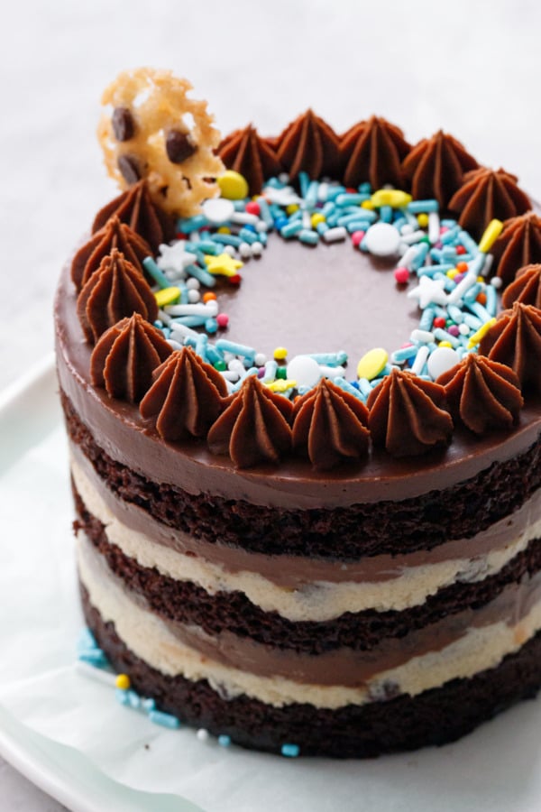 Closeup, backlit layer cake with a ring of blue and yellow sprinkles
