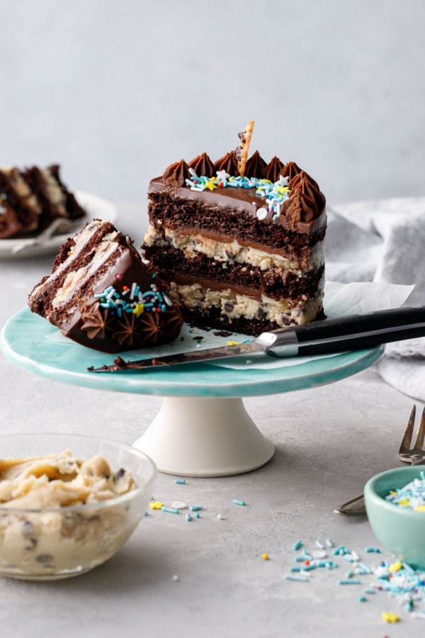 Mini Chocolate & Cookie Dough Naked Layer Cakes cut in half, with slice and knife.