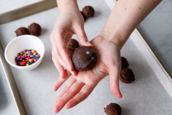 Shaping the cookie dough around the ganache filling