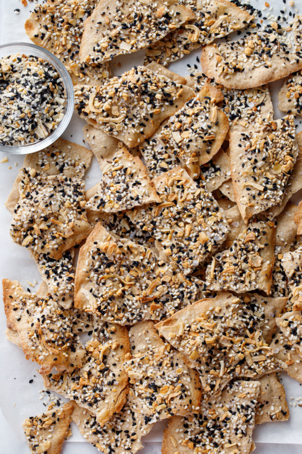 Overhead, broken up cracker pieces with bowl of Everything seasoning blend