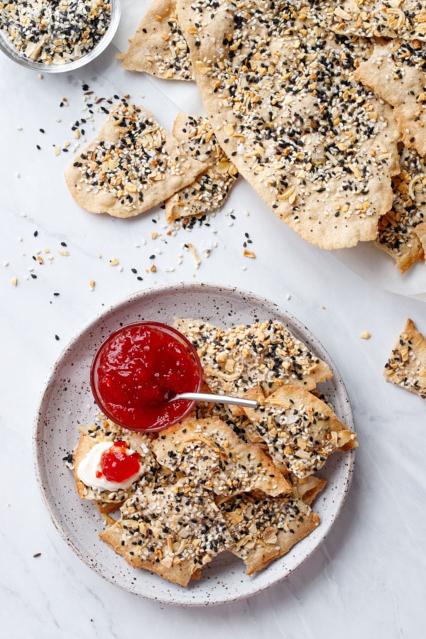 Overhead, Plate with Homemade Everything Crackers, bowl of pepper jelly, one cracker topped with cream cheese and pepper jelly