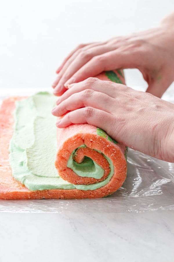 Hands rolling up the cake roll