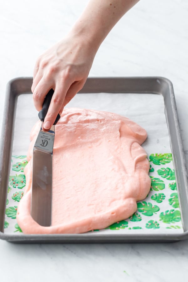 Spreading out the cake batter into an even layer with an offset spatula