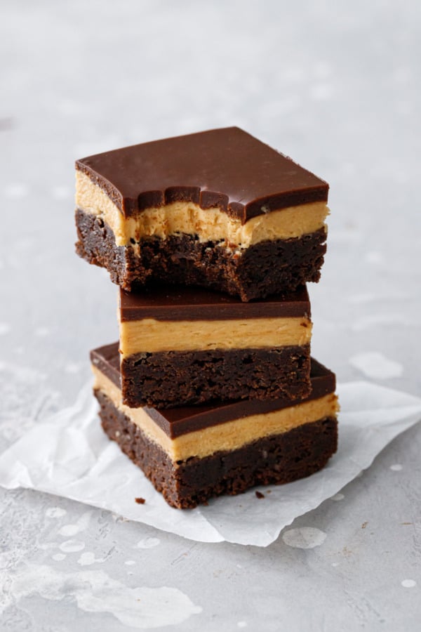 Stack of 3 Milk Chocolate Peanut Butter Ganache Brownies, top one with a bite out of it