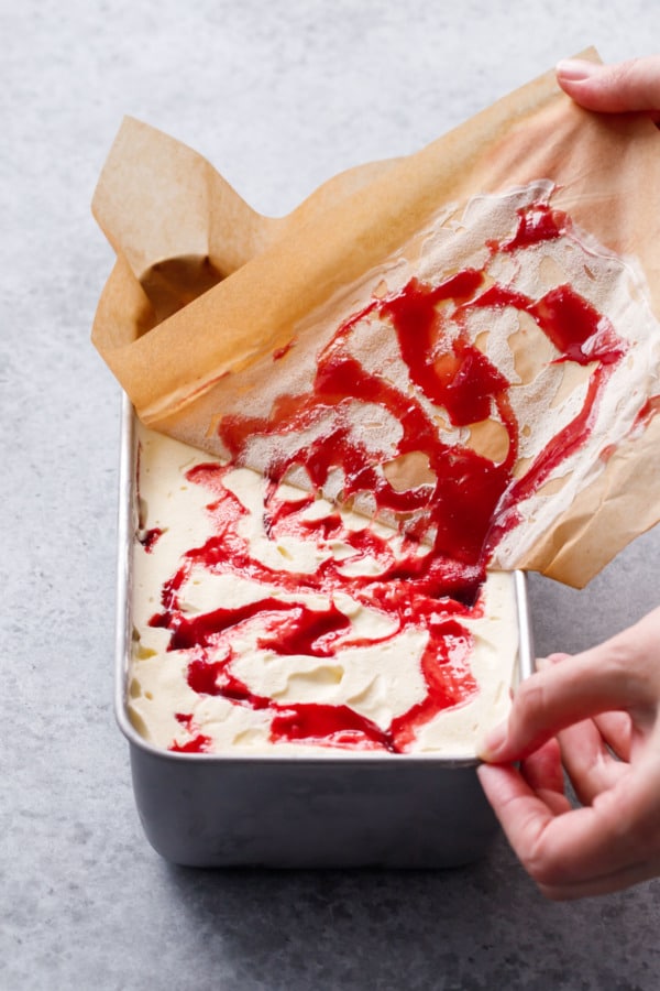 Peeling a layer of parchment paper off the freshly churned ice cream
